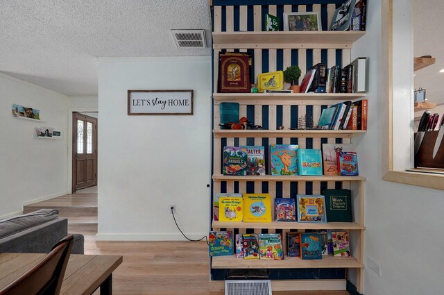 interior space featuring a textured ceiling and light wood-type flooring