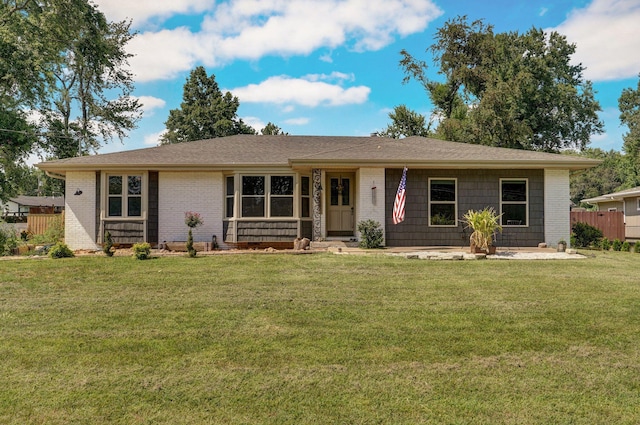 ranch-style home featuring a front yard