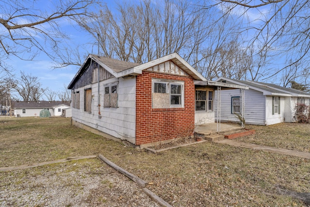 view of side of property with a yard