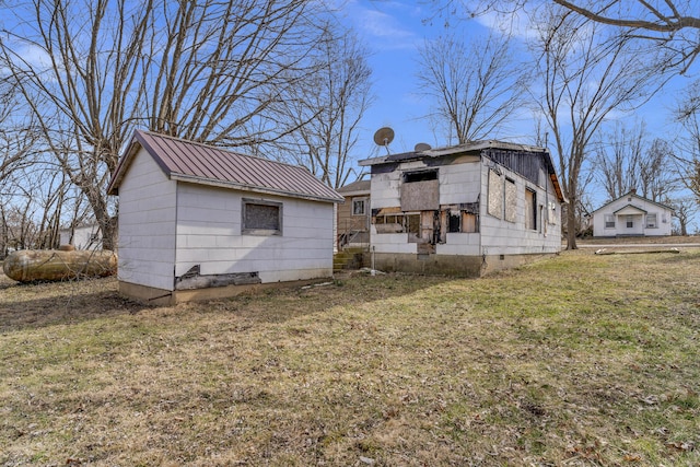 back of house with a lawn