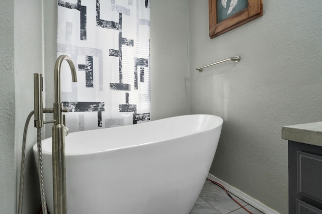 bathroom featuring sink and a washtub