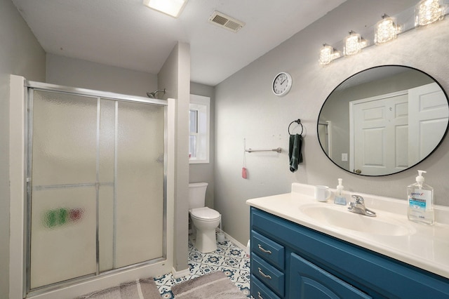 bathroom with an enclosed shower, vanity, and toilet