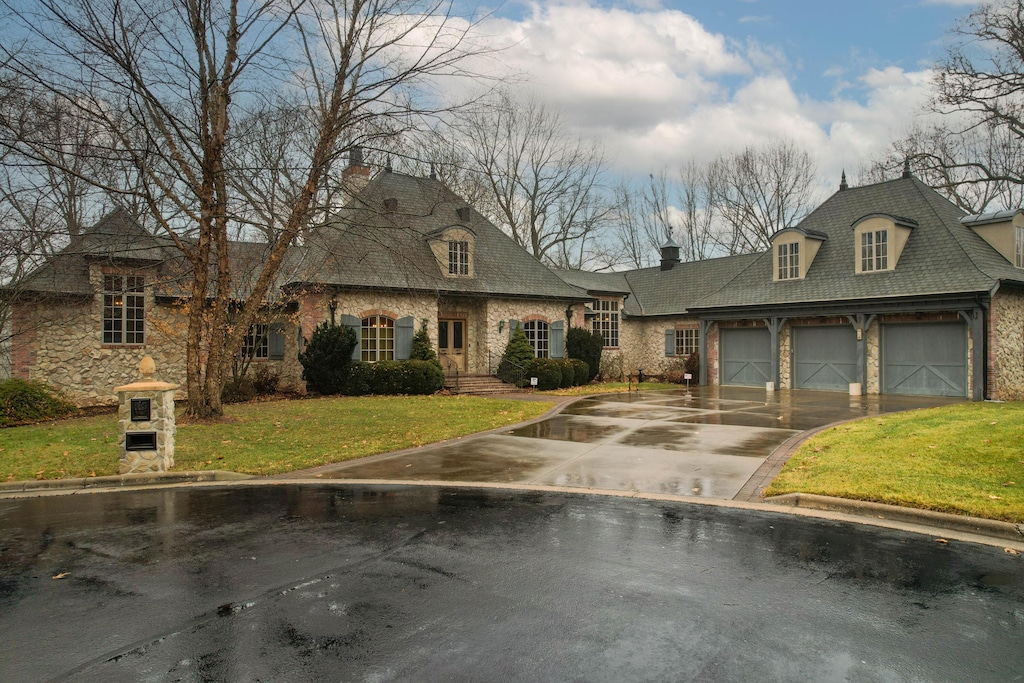 french country style house featuring a front yard