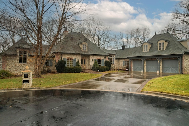 french country style house featuring a front yard