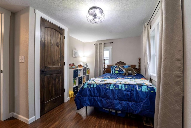 bedroom featuring hardwood / wood-style flooring and a textured ceiling