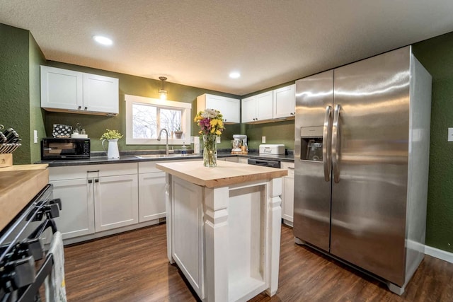 kitchen with wooden counters, stainless steel fridge with ice dispenser, dark hardwood / wood-style flooring, a kitchen island, and white cabinets