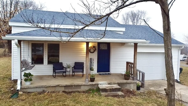 ranch-style house featuring a garage and covered porch