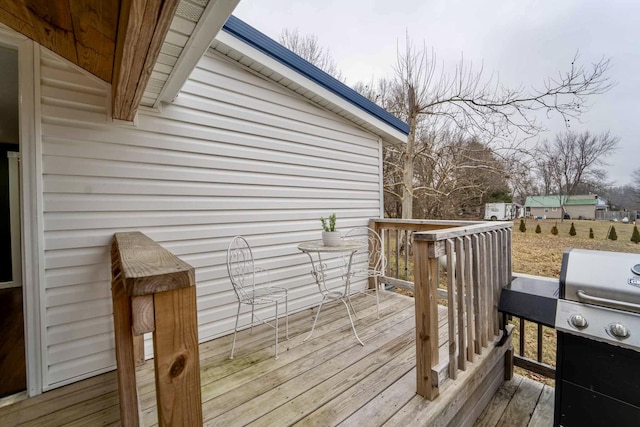 wooden terrace featuring area for grilling