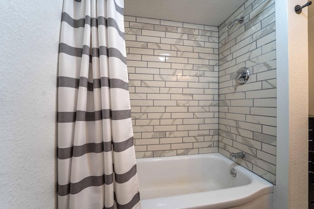 bathroom with shower / tub combo and a textured ceiling