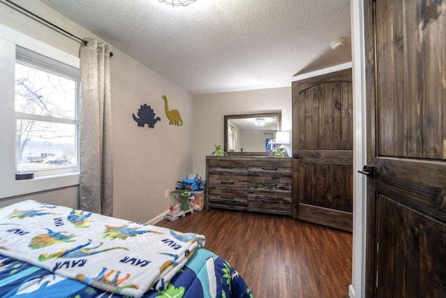 bedroom featuring dark hardwood / wood-style floors and a textured ceiling