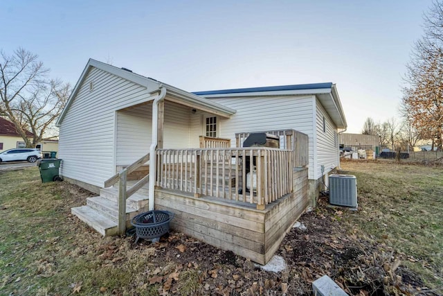 rear view of house featuring cooling unit and a deck