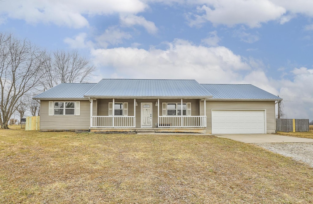 ranch-style home featuring a porch, a garage, and a front lawn