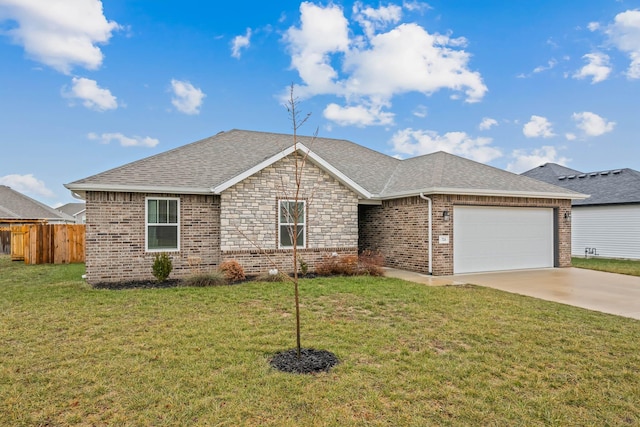 single story home with a garage and a front lawn