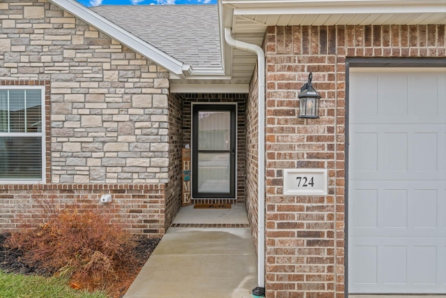 doorway to property featuring a garage