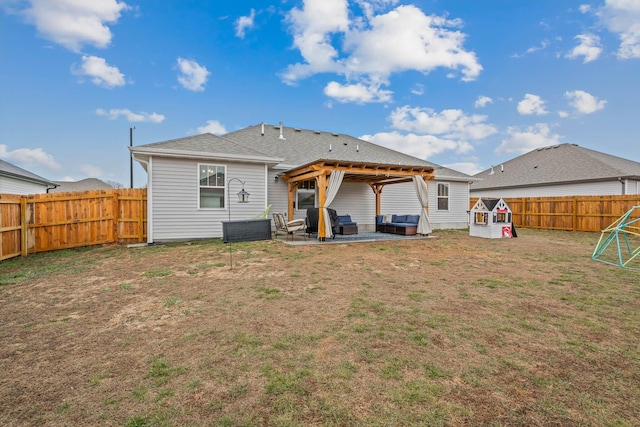 rear view of property featuring a yard, an outdoor hangout area, and a patio area