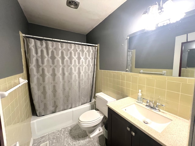 full bathroom featuring vanity, toilet, tile walls, and shower / bath combo