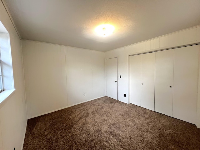 unfurnished bedroom featuring a closet and carpet