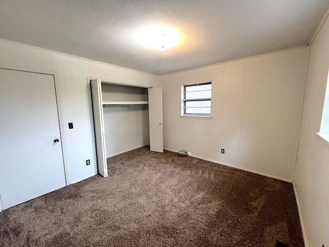 unfurnished bedroom featuring carpet floors and a closet