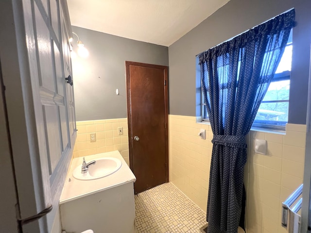 bathroom featuring tile walls, vanity, and tile patterned flooring