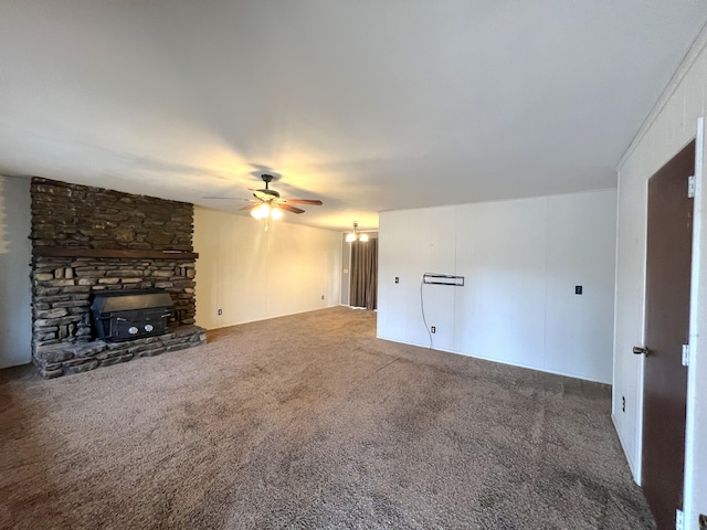 unfurnished living room with a stone fireplace, carpet flooring, and ceiling fan