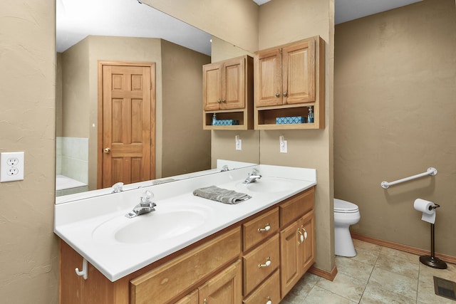 bathroom featuring vanity, toilet, and tile patterned flooring