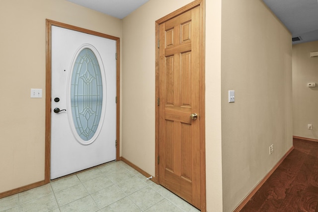 foyer entrance featuring light tile patterned flooring