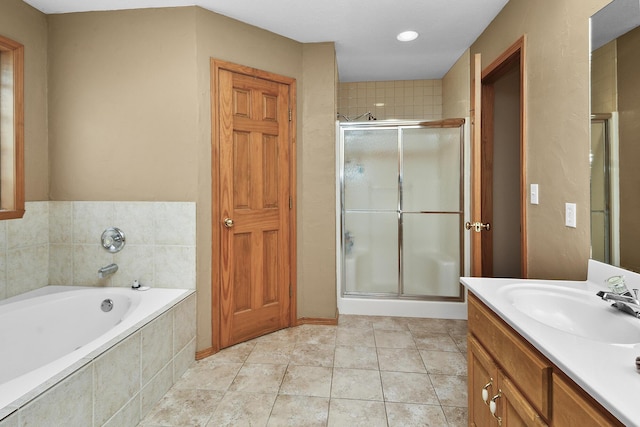 bathroom with independent shower and bath, vanity, and tile patterned floors