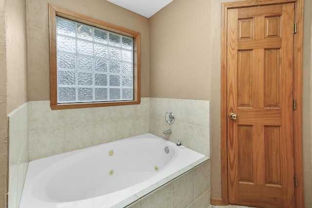 bathroom with a relaxing tiled tub