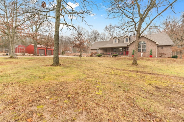 view of yard with a porch and a garage