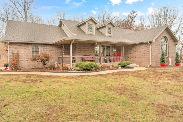 view of front of home with a front yard and covered porch