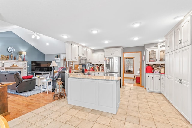 kitchen with white cabinetry, appliances with stainless steel finishes, and light tile patterned floors