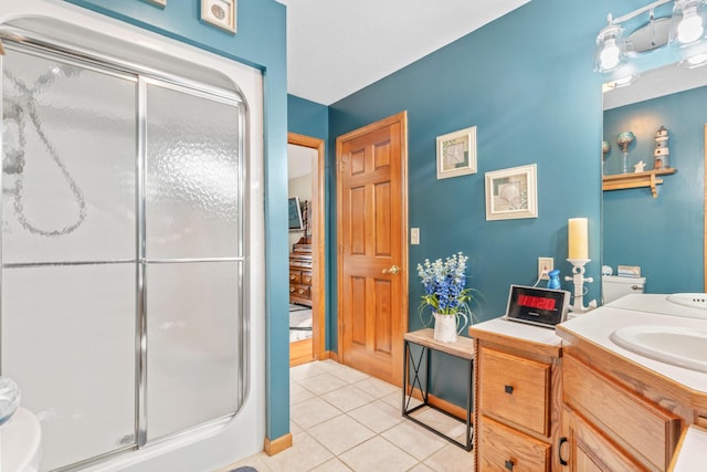 bathroom featuring vanity, tile patterned floors, and walk in shower