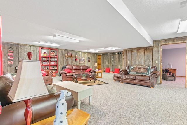 carpeted living room featuring wooden walls