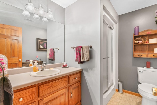 bathroom featuring tile patterned floors, toilet, a shower with door, and vanity