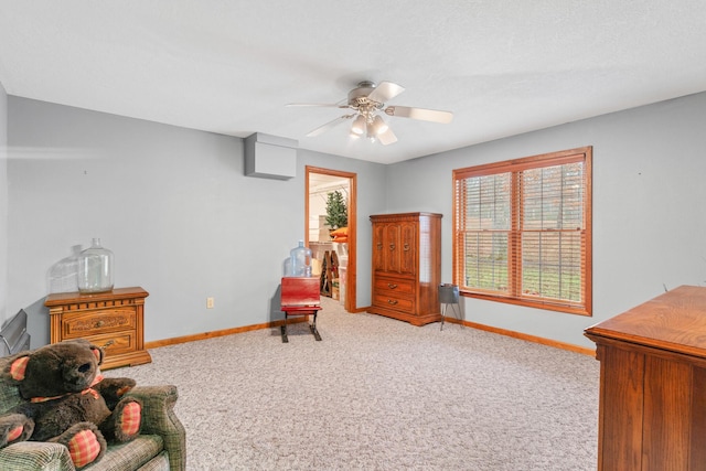 sitting room featuring ceiling fan and carpet floors