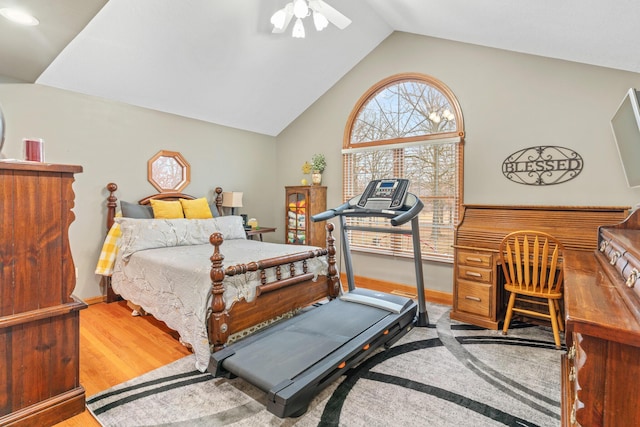 bedroom with vaulted ceiling, ceiling fan, and light hardwood / wood-style floors