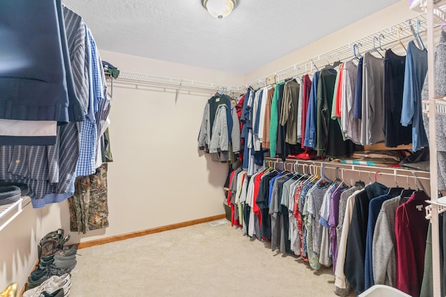 walk in closet featuring carpet floors