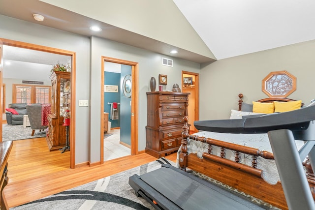 bedroom with lofted ceiling and light hardwood / wood-style floors