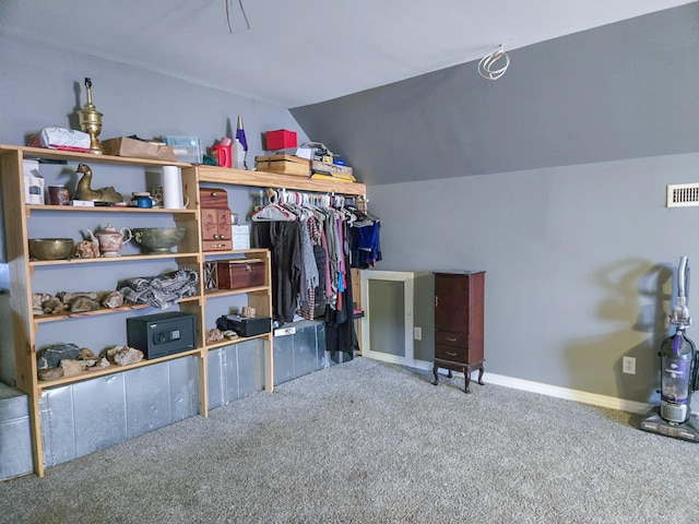 walk in closet with lofted ceiling and carpet floors