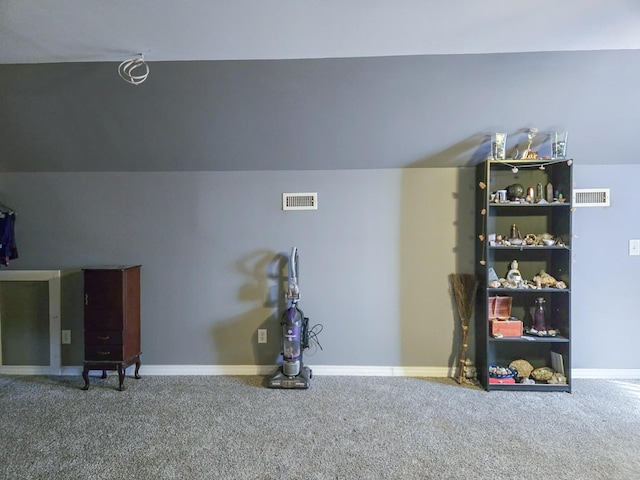 interior space with carpet flooring and vaulted ceiling