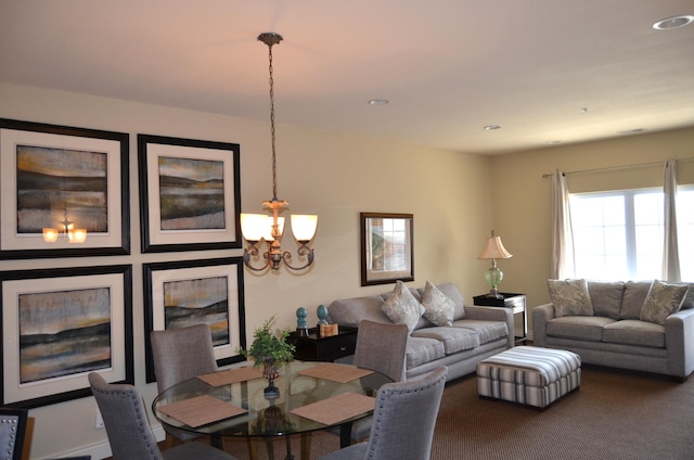 dining room with an inviting chandelier and carpet