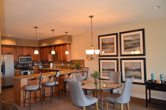 dining room featuring sink and a chandelier