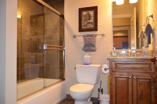 full bathroom with vanity, toilet, tile patterned flooring, and combined bath / shower with glass door