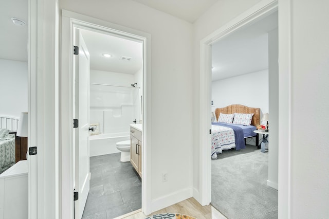 ensuite bathroom featuring visible vents, connected bathroom, baseboards, and bathtub / shower combination