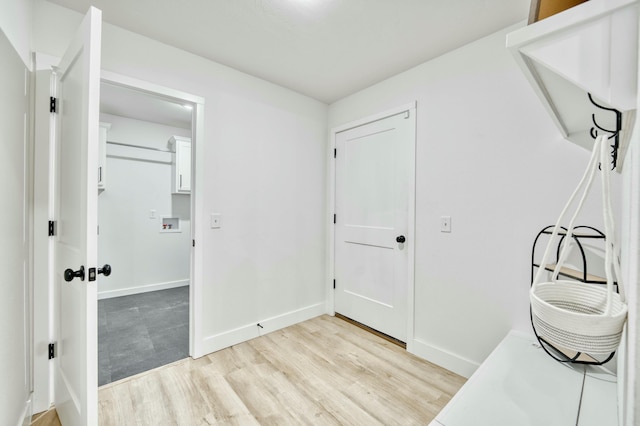 interior space featuring light wood-style flooring and baseboards