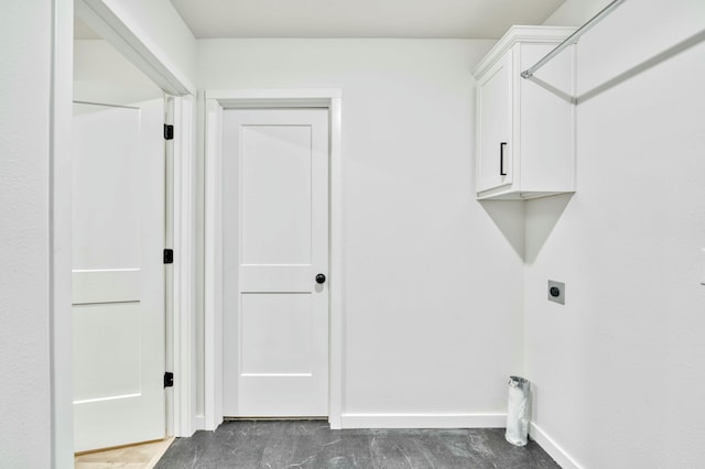 laundry area with baseboards, hookup for an electric dryer, and cabinet space