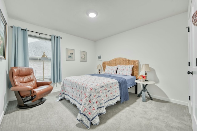 carpeted bedroom featuring baseboards