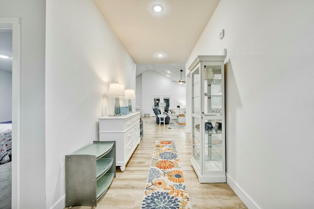 hallway featuring recessed lighting, baseboards, and light wood-style floors