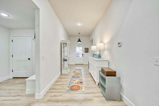 interior space featuring recessed lighting, light wood-style floors, and baseboards