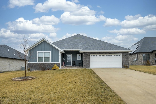 ranch-style home with board and batten siding, a shingled roof, concrete driveway, a front yard, and a garage